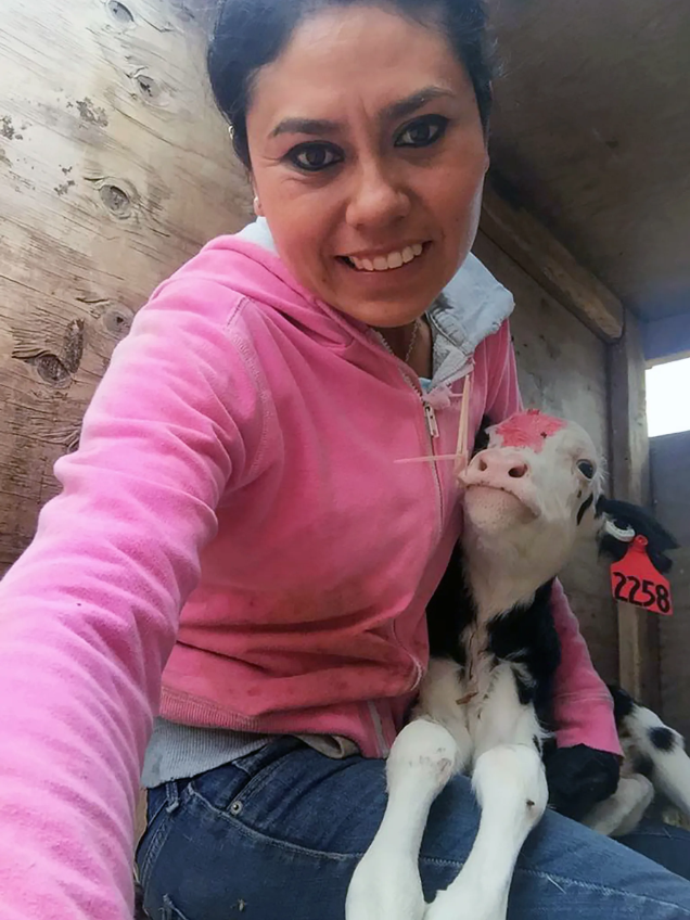 Leslie Ortiz with a newborn dairy cow. Image courtesy of Leslie Ortiz. United States, 2019.