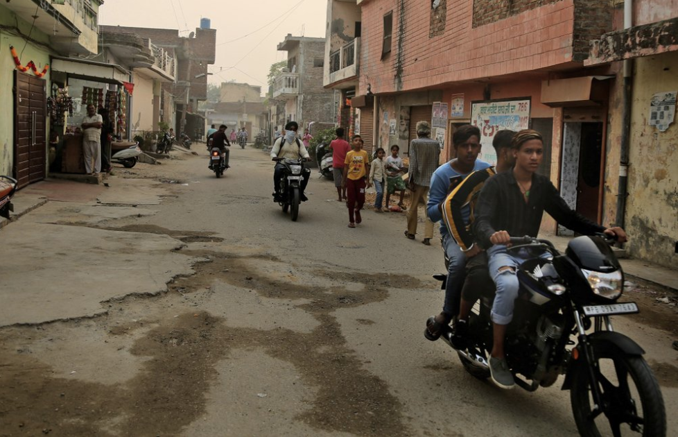 In this Oct. 31, 2019, photo, Indian boys ride a motorcycle in Kapurthala, in the northern Indian state of Punjab. India has twice the global average of illicit opiate consumption. Researchers estimate 4 million Indians use heroin or other opioids, and a quarter of them live in the Punjab, India’s agricultural heartland bordering Pakistan, where some of the most vulnerable are driven to drugs out of desperation. Image by Channi Anand / AP Photo. India, 2019.