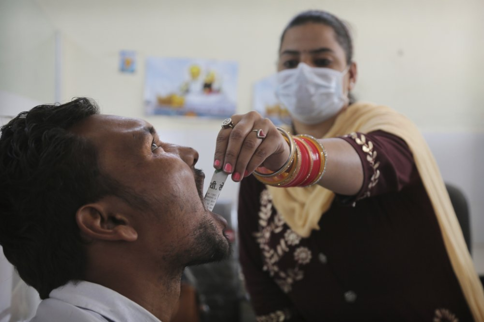 In this Thursday, Oct. 31, 2019, photo, a medic administers medicine to a recovering drug user at a de-addiction center in Kapurthala, in the northern Indian state of Punjab. Researchers estimate about 4 million Indians use heroin or other opioids, and a quarter of them live in the Punjab, India's agricultural heartland bordering Pakistan. These pills, the world had been told, were safer than the OxyContins, the Vicodins, the fentanyls that had wreaked so much devastation. But now they are the root of what the United Nations named “the other opioid crisis," an epidemic featured in fewer headlines than the American one, as it rages through the most vulnerable places on the planet. Image by Channi Anand / AP Photo. India, 2019.