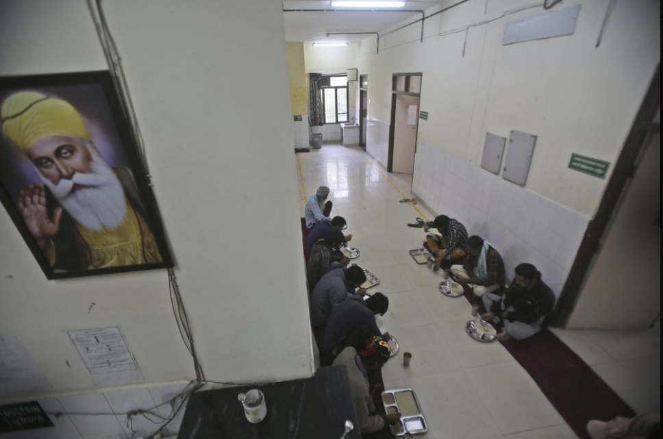 In this Thursday, Oct. 31, 2019, photo, recovering drug users eat a meal at a de-addiction center in Kapurthala, in the northern Indian state of Punjab. India has twice the global average of illicit opiate consumption. Researchers estimate 4 million Indians use heroin or other opioids, and a quarter of them live in the Punjab, India’s agricultural heartland bordering Pakistan, where some of the most vulnerable are driven to drugs out of desperation. Image by Channi Anand / AP Photo. India, 2019.