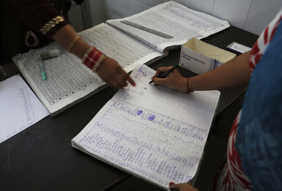 In this Thursday, Oct. 31, 2019, photo, a recovering tramadol drug user signs a register after taking her medication at a de-addiction center in Kapurthala, in the northern Indian state of Punjab. India has twice the global average of illicit opiate consumption. Researchers estimate 4 million Indians use heroin or other opioids, and a quarter of them live in the Punjab, India’s agricultural heartland bordering Pakistan, where some of the most vulnerable are driven to drugs out of desperation. Image by Channi Anand / AP Photo. India, 2019.