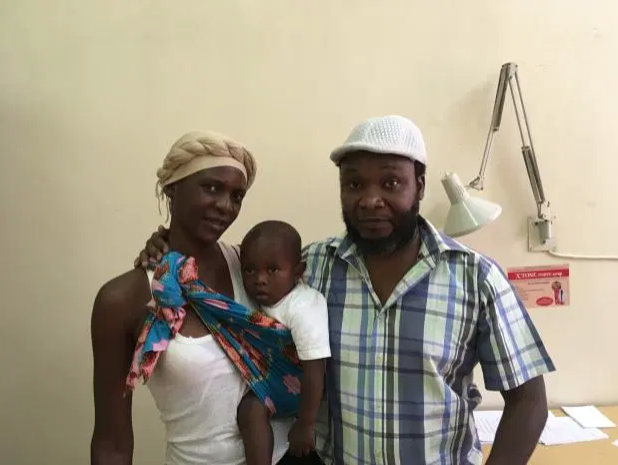 Zacheaus Chikasa (right), who suffered a stroke in 2015, with his wife and grandson. Image by Oliver Staley/ Quartz. Zambia, 2019.