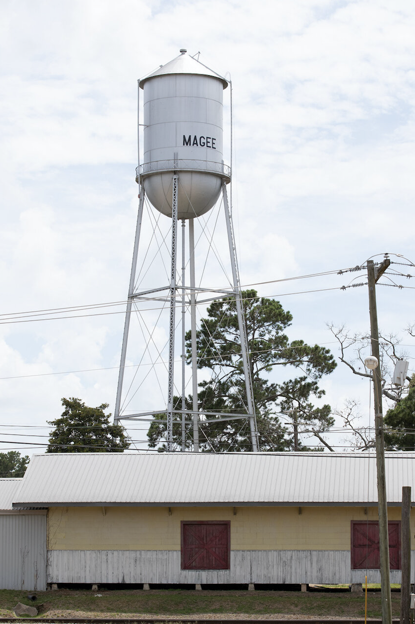 The Magee, MS water tower stands not far from the parking lot at the main entrance to Magee General Hospital in Magee. The hospital was incorporated in 1942 and primarily serves Simpson County's rural population. Image by Sarah Warnock/MCIR. United States, undated.
