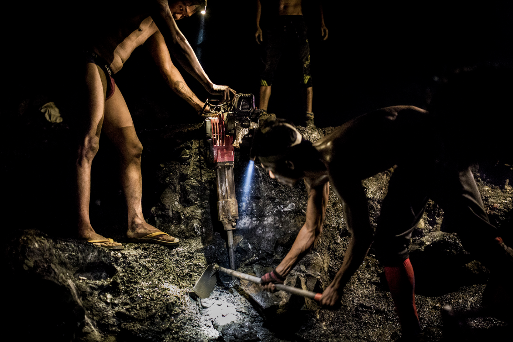Miners use jackhammers and headlamps to search for jade at night in Hpakant on Aug. 15, 2018. Image by Hkun Lat. Myanmar, 2018. 