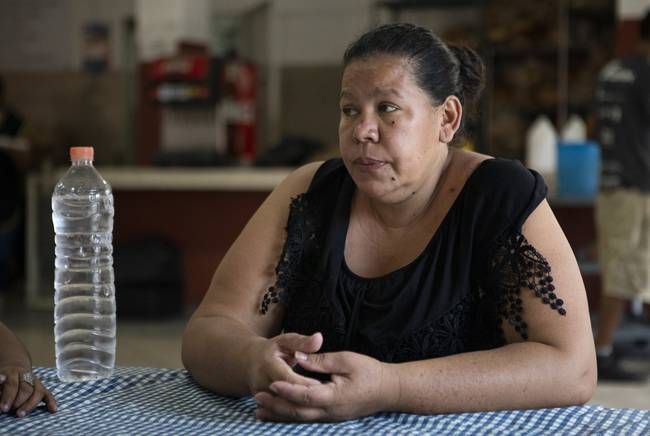 Anjelica Zavala sits at a table in the dining room at Casa Indi. According to Zavala, her parents, husband and cousins were murdered by gangs in El Salvador. Zavala has an asylum hearing scheduled for the fall. Aug. 6, 2019. Image by Miguel Gutierrez Jr. Mexico, 2019.