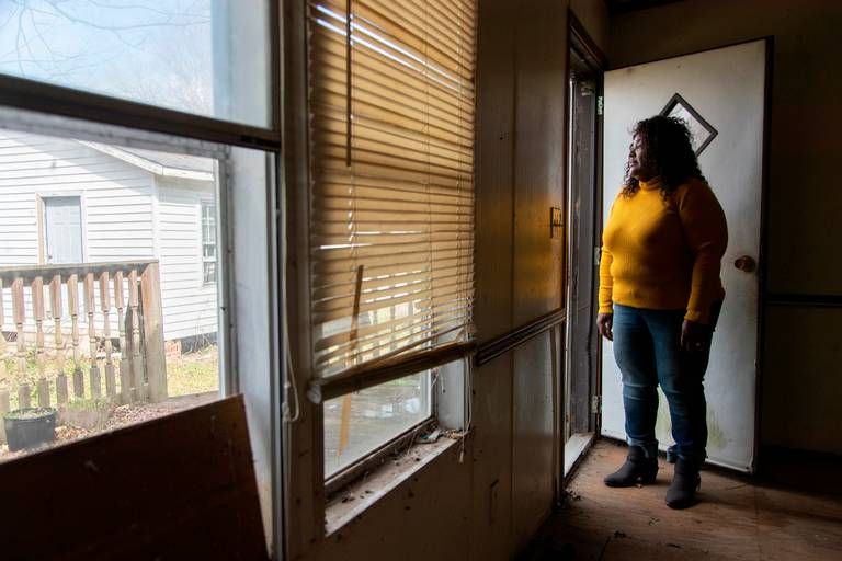 Sellers, South Carolina, Mayor Barbara Hopkins shows homes damaged by repeated flooding and hurricanes on February 13, 2020. While many homeowners across the small town have received help from FEMA and other natural disaster response agencies, those without a clear title for their home have been left with no government help in mold saturated homes. Image by Joshua Boucher. United States, 2020.
