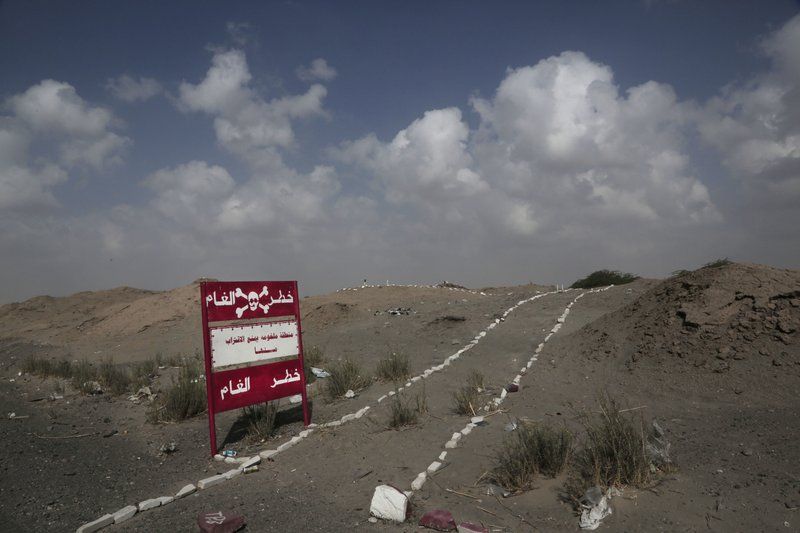 This Feb. 15, 2018, photo shows a sign with Arabic that reads, “danger mines, danger mines” on the highway from Abyan to Aden in Yemen. Image by Nariman El-Mofty. Yemen, 2018. 

