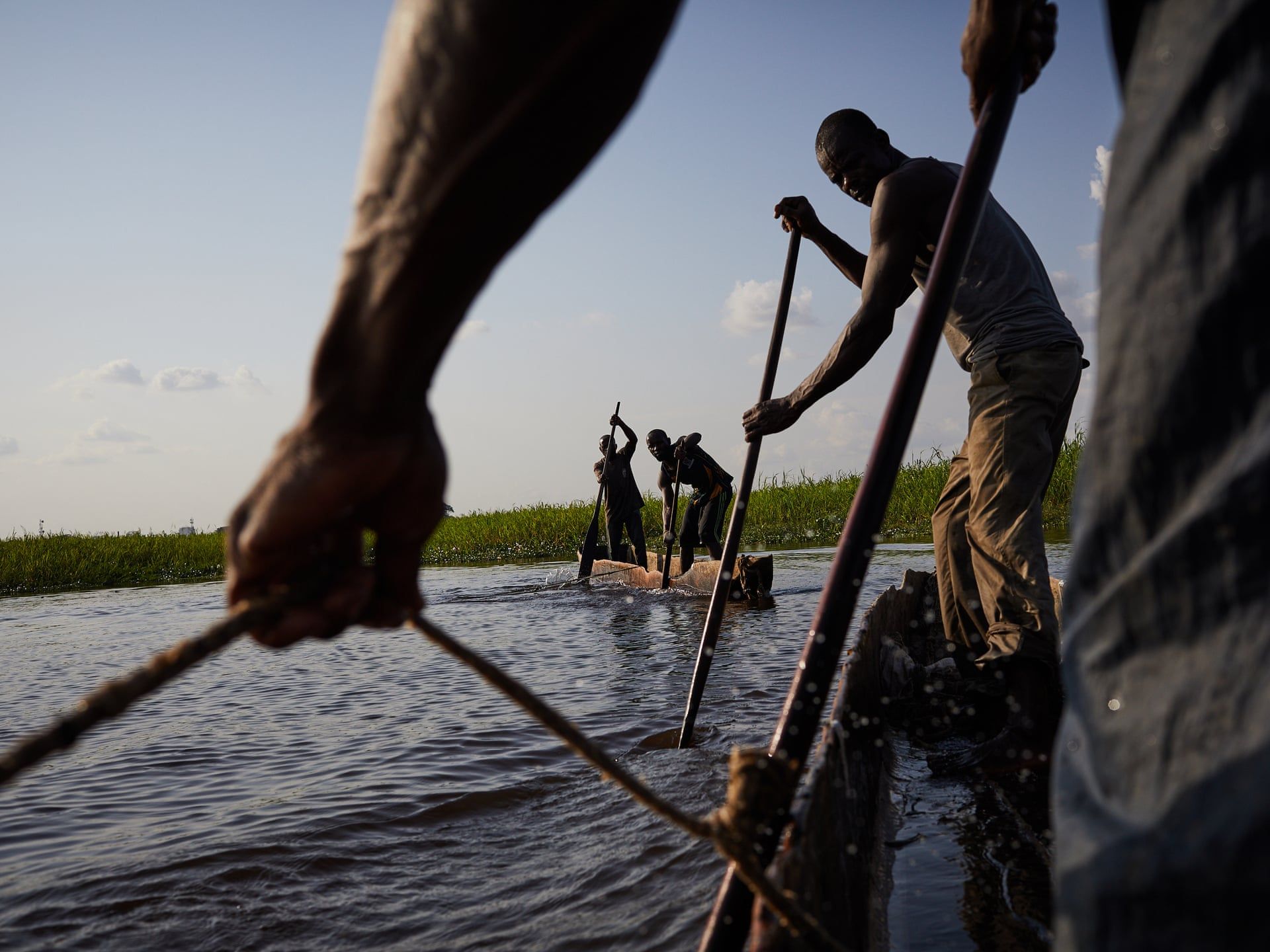 Fisherman on the Congo river, Kinshasa. Fishing is the principal activity that brings humans into contact with snakes in DRC. Snakes often are often caught in nets, or hunt for fish themselves in the water and on the shores. Image by Hugh Kinsella Cunningham. Congo, 2019.
