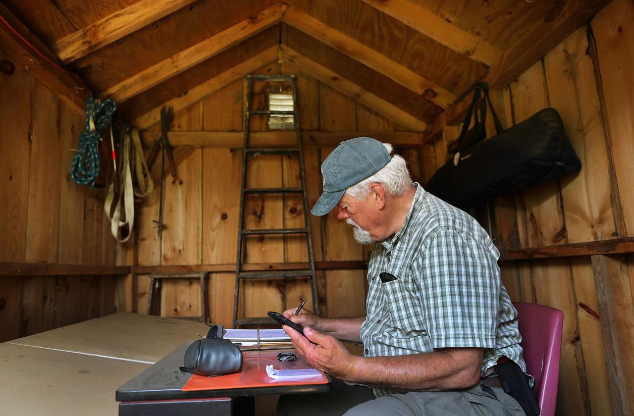 The shed where he records data has been moved back repeatedly because of cliff erosion. Image by John Tlumacki. United States, 2019.