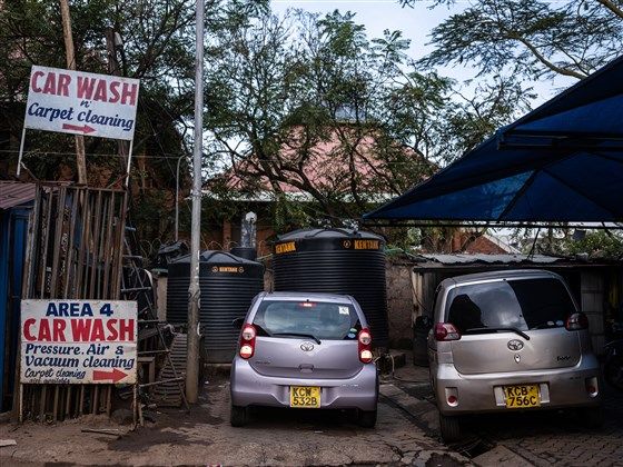 An Uber driver in Nairobi, Kenya, gets ready last month to pull out of the car wash where he parks his vehicle each night and begin his work day. Image by Nichole Sobecki/NBC News. Kenya, 2020.
