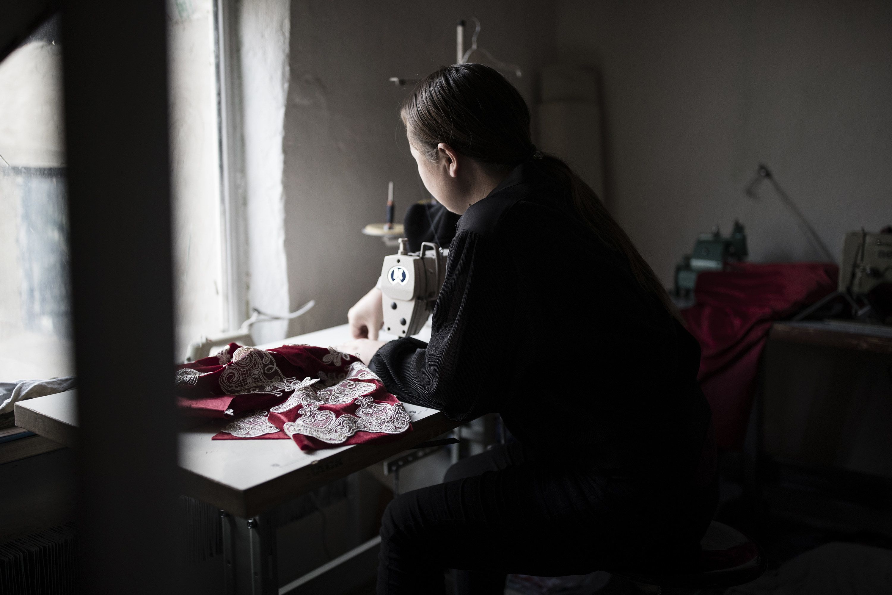 Dina Nurdybai working in her sewing workshop at her home in Almaty, Kazakhstan, Feb. 25, 2020. Image by Ekaterina Anchevskaya / Buzzfeed News. Kazakhstan 2020.