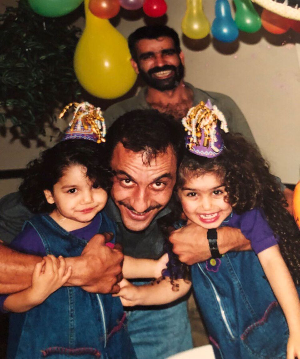 Zahra Ahmad, right, her uncle Mike Mahdi, center, her sister Hawra Ahmad, left, and her father Mohammad Sibte, back, celebrate a birthday. Image courtesy of Ahmad family.