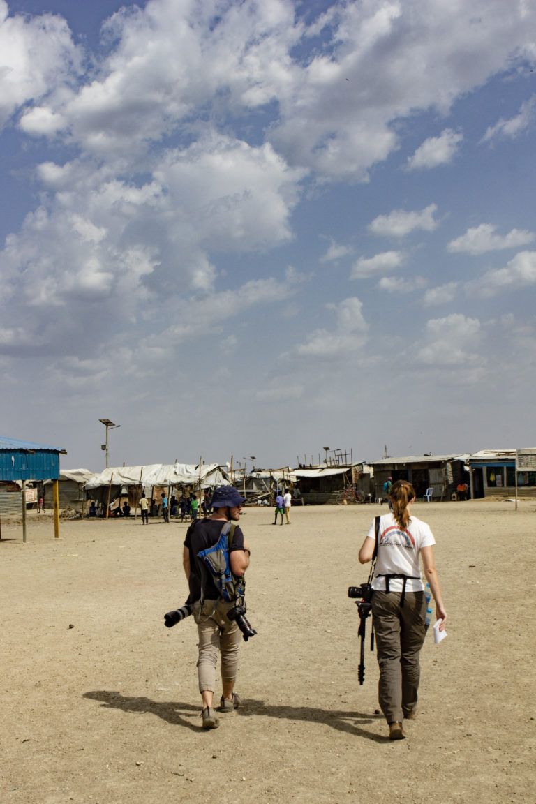 Thomas Holder and Kristen van Schie from African Defence Review at work in the Malakal protection of civilians site in Upper Nile, South Sudan. Image by Richard Stupart / African Defence Review. South Sudan, undated.