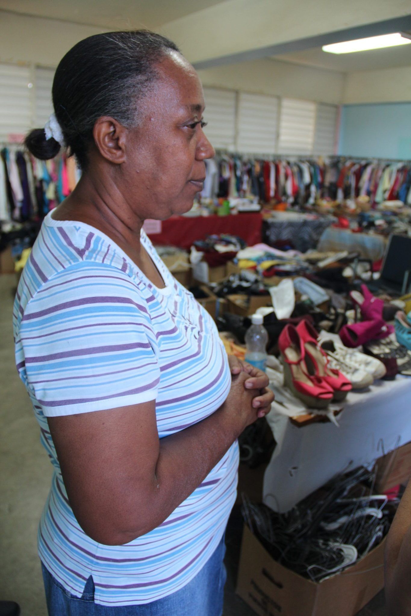 Evelyn Allende in the clothing center at the Parcelas Suárez community center. Image by Kari Lydersen. Puerto Rico, 2019.