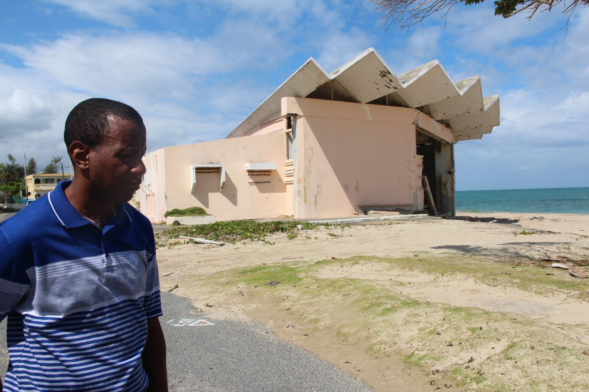Alexis Correa Allende and the destroyed community center on the beach in Parcelas Suárez. Image by Kari Lydersen. Puerto Rico, 2019.