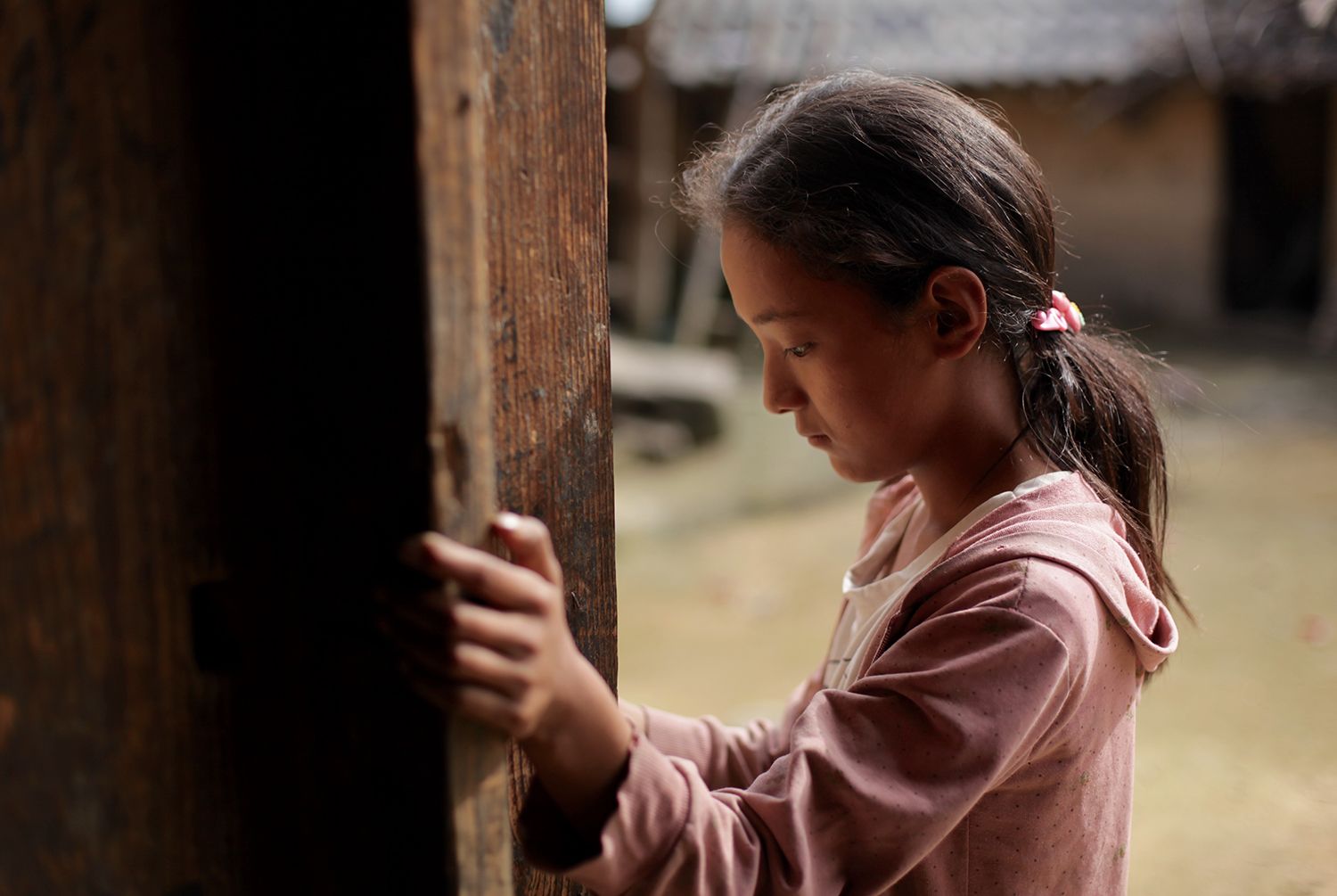 Wang Bing stands by the door of her family’s farmhouse in Liangshan, July 2016. Image by Max Duncan.