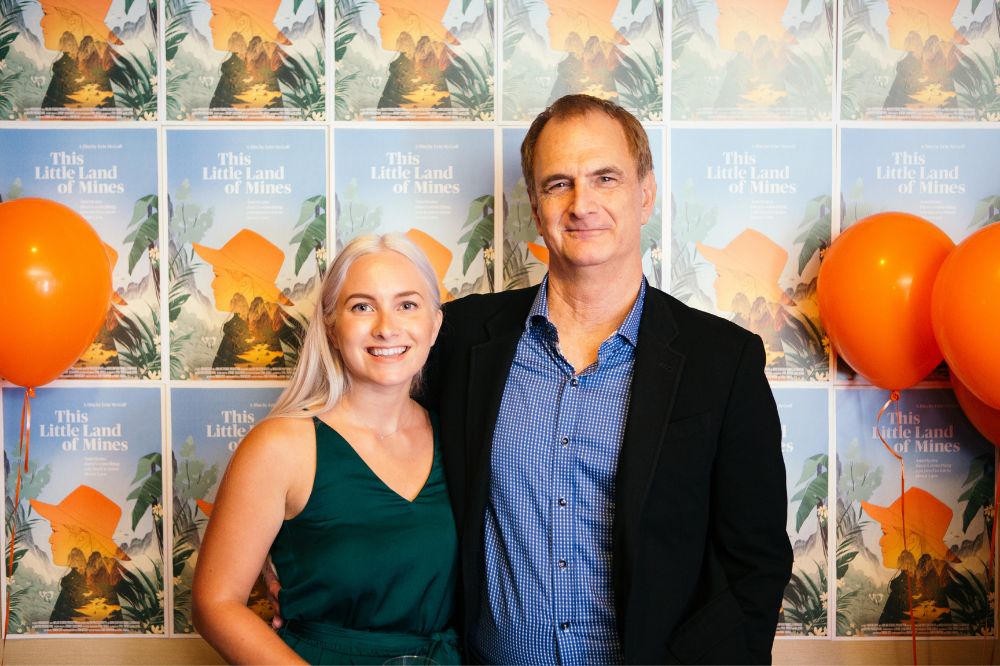 Executive Producer Don Thompson and filmmaker Erin McGoff stand for a photo in front of posters for 'This Little Land of Mines.' Image by Matt Francisco. United States, 2019.
