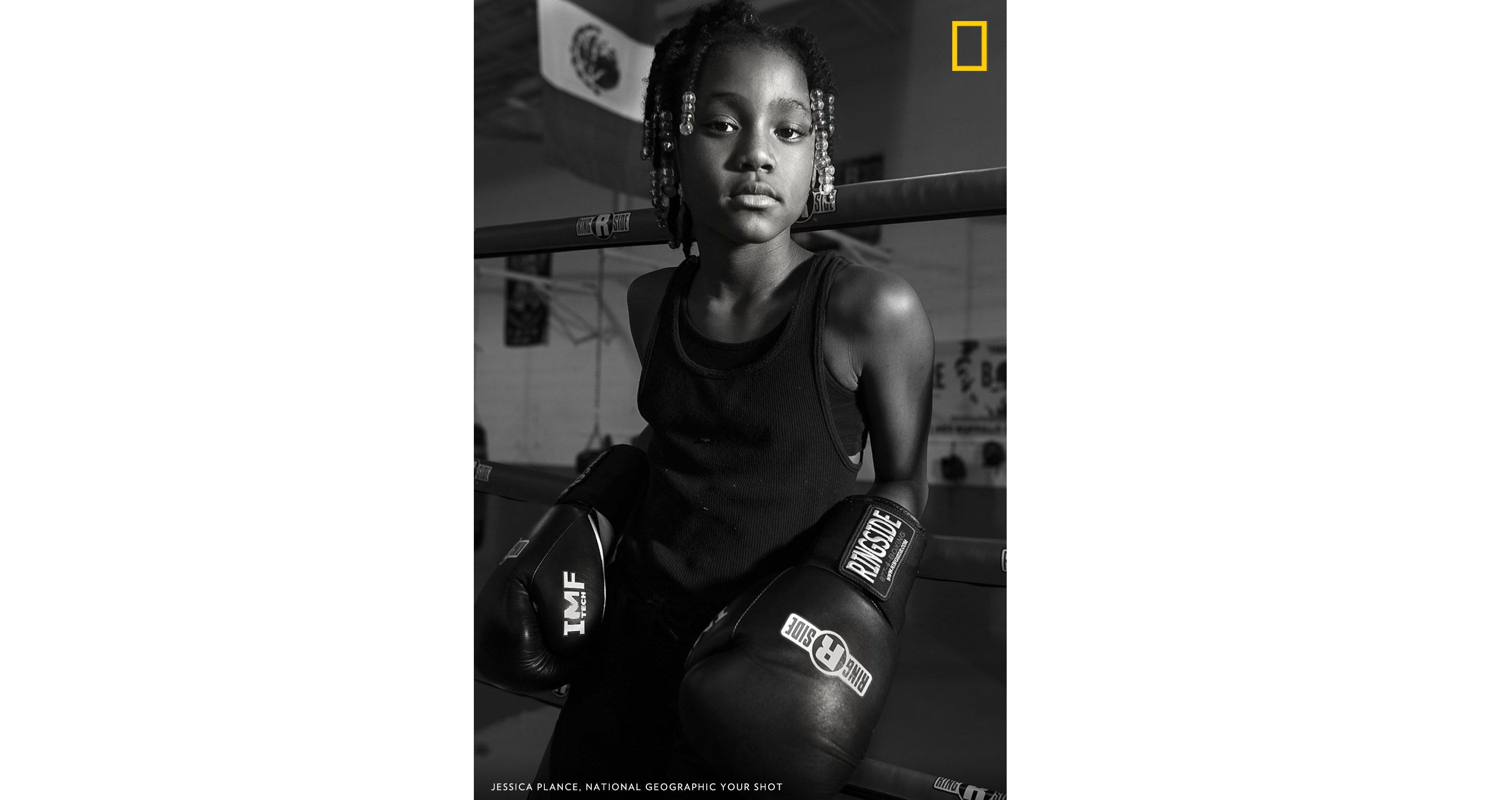 Nevaeha Nelson, also known as Ya-Ya, poses for a portrait at Future Boxing Club in Downtown Rochester. The Future Boxing Club is an afterschool program for the youth of Rochester, and was designed to keep the children off the streets. I asked Ya-Ya who is one of the only girls who boxes here to look at me like one of the guys had beat her in a fight. ‘The boys never beat me’ was how she responded. Image by Jessica Plance. United States.
