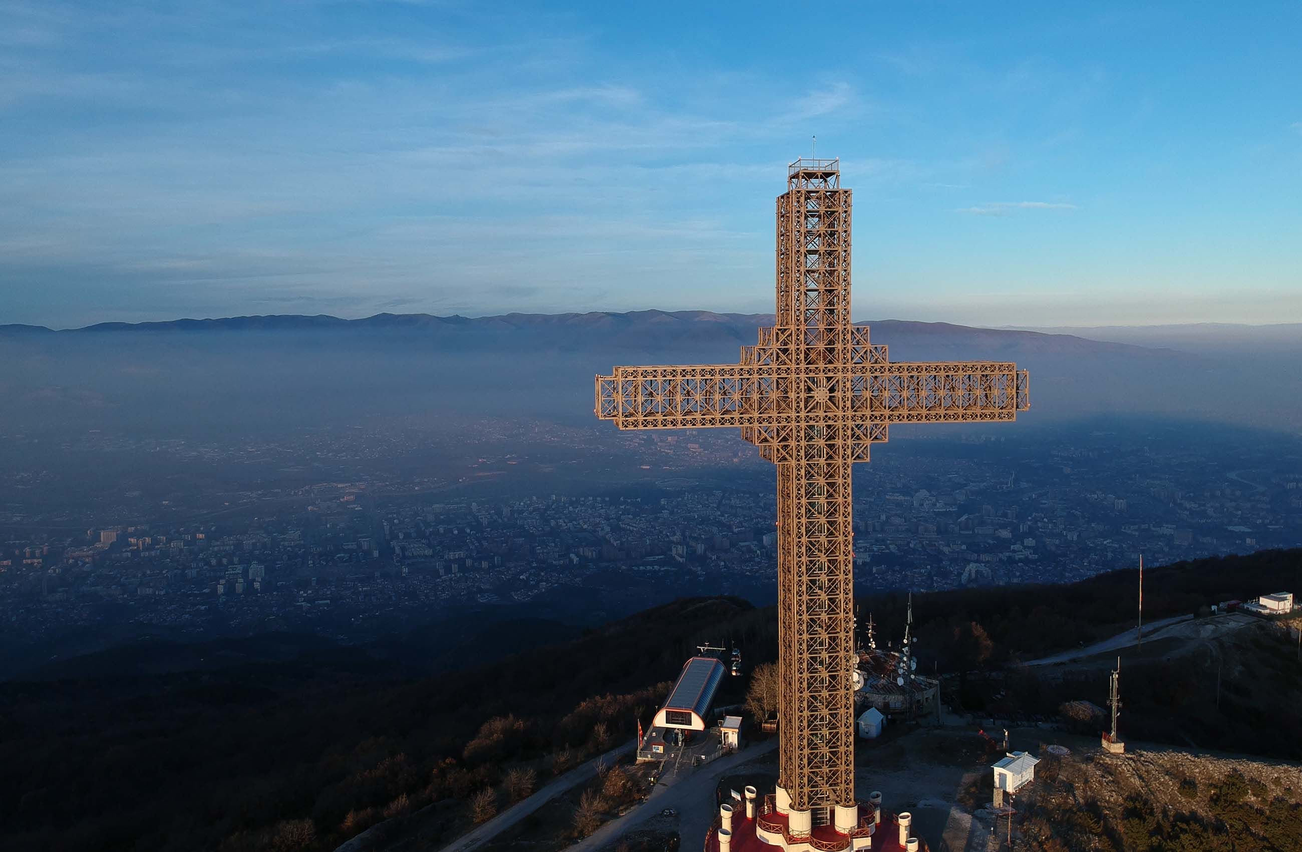 A cross atop Mt. Vodno looks down over hazy Skopje. Whether 2019 will bring clearer air is an open question, but many say they are hopeful. Image by Larry C. Price. Macedonia, 2018.