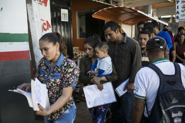 Migrants line up in Tapachula to have their paperwork processed. Image by Jose Cabezas. Mexico, 2018. 