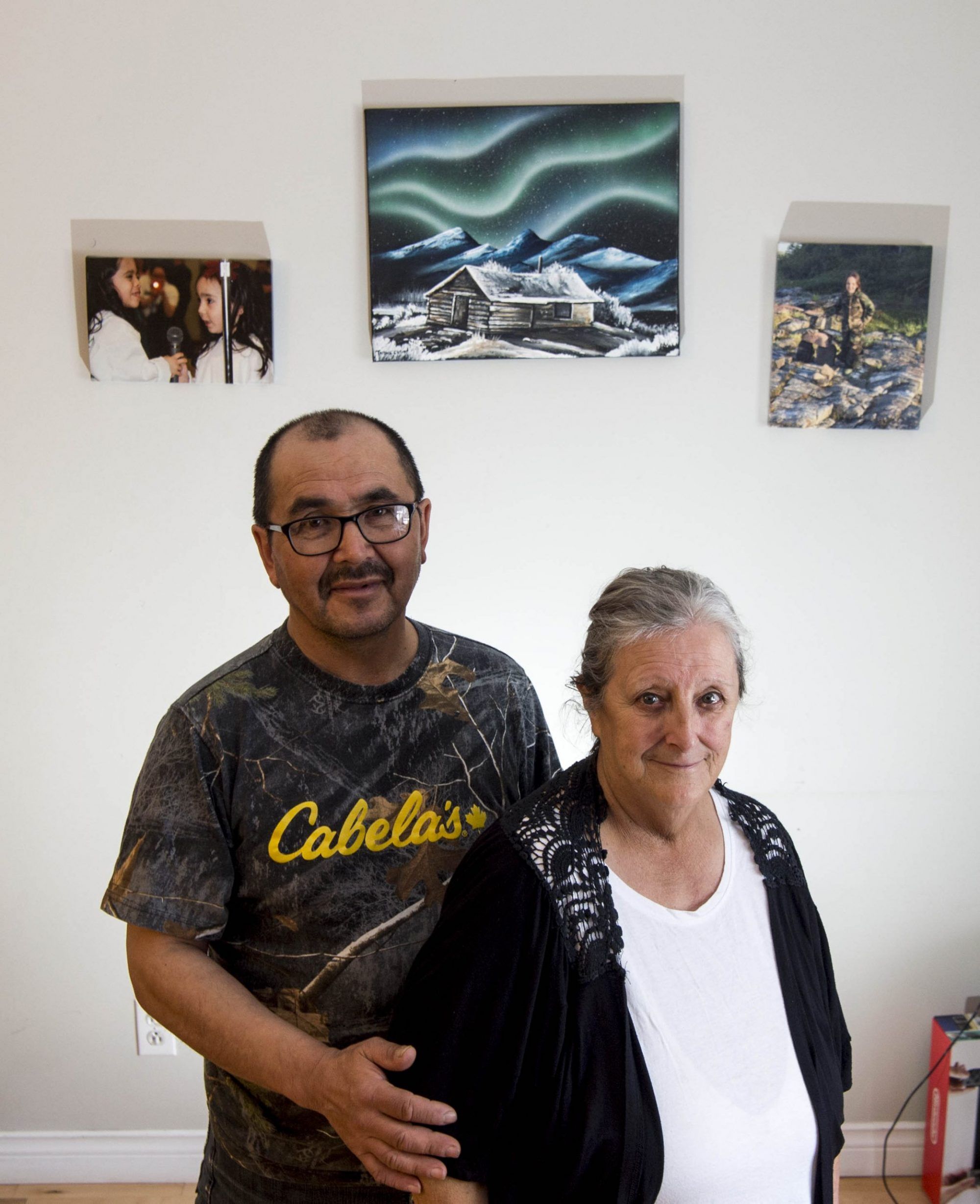 David and Charlotte Wolfrey pose for a portrait in their home in Rigolet, Labrador. Charlotte, an elder and elected leader of the small Inuit community of Rigolet, worries that methylmercury poisoning from a recently completed hydropower project will destroy the community's deep cultural connection to seals and other wild-caught food. Image by Michael Seamans / The Weather Channel. Canada, 2019.

