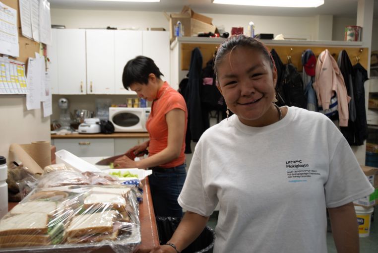 At Qajuqturvik Food Centre in Iqaluit, Marilyn Aupaloosie helps prepare meals for local residents. 'It’s my motivation,' she says of her work. 'I like to see the smiling faces.' Image by Julie De Meulemeester. Canada, 2018. 
