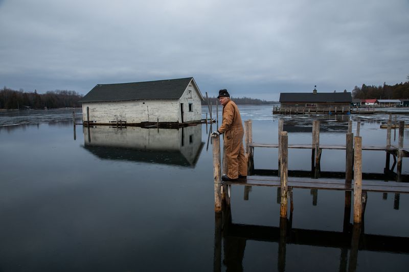Mark Engle, owner of the Les Cheneaux Landing resort in Snows Channel at Les Cheneaux Islands, recently elevated and rebuilt his boat docks because of rising waters. Image by Zbigniew Bzdak / Chicago Tribune. United States, 2020.