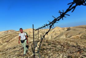 Striding toward Bethlehem, in the West Bank, Salopek is detoured by a herder’s tattered fence, one of the first human-made barriers—other than checkpoints and border gates—he’s faced in some 2,300 miles since he started out in Ethiopia. Image by John Stanmeyer/National Geographic.