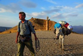 In eastern Turkey, Paul Salopek leads his mule past the Karakuş royal tomb, built in the first century B.C. by one of the area’s many ruling states. When Syrians began to pour over the border 70 miles to the south, he and photographer John Stanmeyer drove down separately to report on the situation. Image by by John Stanmeyer/National Geographic.