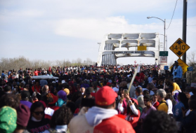 Marchers commemorating the ‘Bloody Sunday’ events of 1965 approach the Edmund Pettus Bridge, in Selma, Alabama, this past Sunday. Image by Brittany Gibson. United States, 2020.