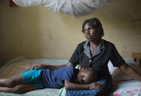 Christine Namatovu and her son Andrew bring solace to each other in the house Namatovu’s in-laws tried to seize when her husband died. Pushing widows off their property is common practice in this region; Namatovu, with the help of lawyers, fought back. Image by Amy Toensing. Uganda, 2016.