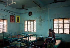 A pregnant woman waits for delivery at the primary health centre in Borsul village. Primary health centers typically provide basic health care services as well as antenatal and postnatal care for women. Image by Sami Siva. India, 2014.