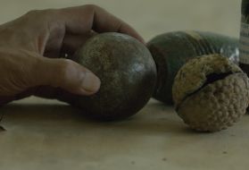 The UXO Lao Province coordinator explains how similar petanque balls and cluster bombs are. Image by Erin McGoff. Laos, 2017.