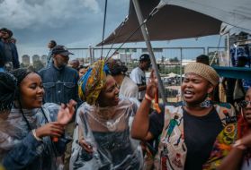 While the Afropunk Joburg festival was on pause because of the weather, crowds make their own music, singing freedom songs. Image by Melissa Bunni Elian. South Africa, 2017.