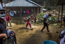 When men leave to find work in the United States, their tasks at home, like carrying wood, are left to wives and children, like these in Bulej, Guatemala. Image by Simone Dalmasso / For the Arizona Daily Star. Guatemala, 2019. 