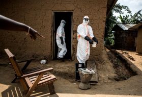 Ebola responders disinfect a home in Aloya in which three people have died. Image by John Wessels. Democratic Republic of Congo, 2019.
