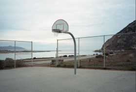 View of Morro Bay, California, from the basketball court. In California, land seized from the Chumash, Yokuts, and Kitanemuk tribes by unratified treaty in 1851 became the property of the University of California and is now home to the Directors Guild of America. Image by Kalen Goodluck / High Country News. United States, 2020.